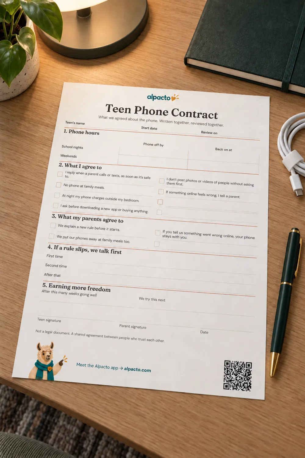 A blank cell phone contract for teens in the minimal design, lying on a desk beside a pen, a notebook and a charging cable.