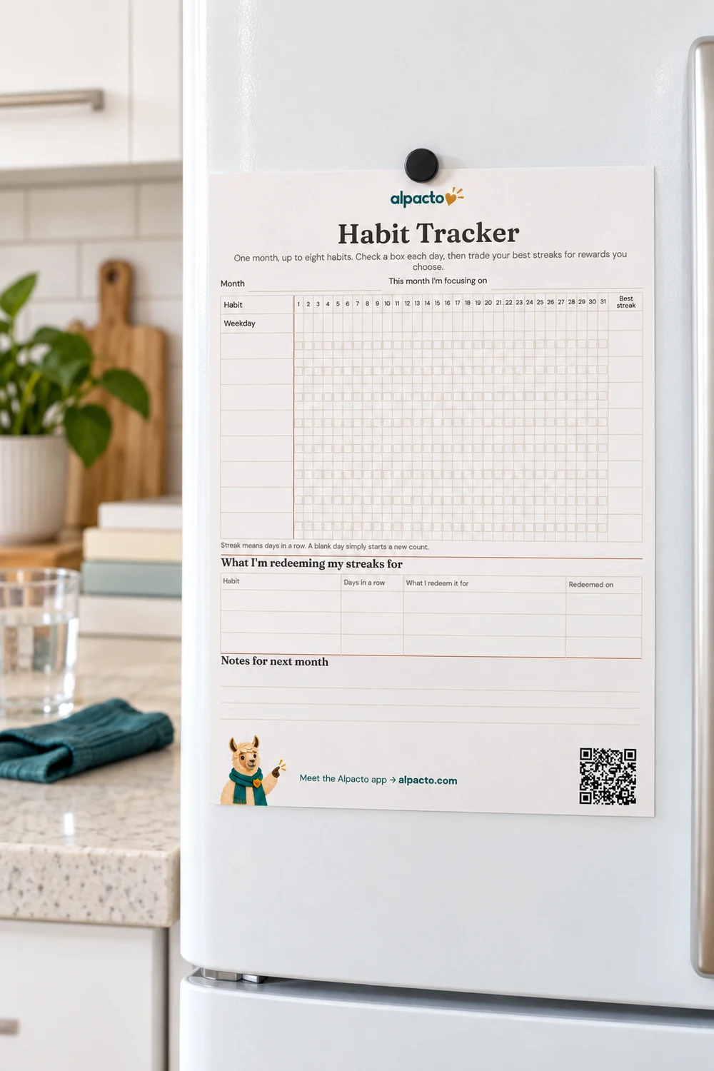 A blank printable habit tracker for one month on a desk, thirty-one day columns and eight habit rows.
